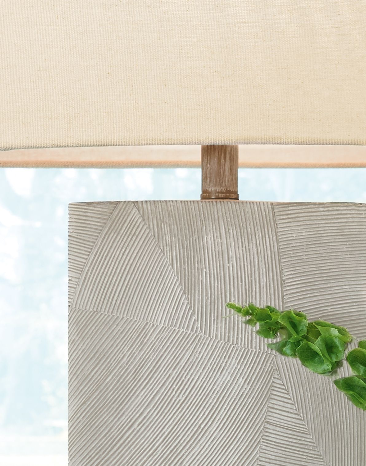Table lamp close-up with beige shade and textured poly base