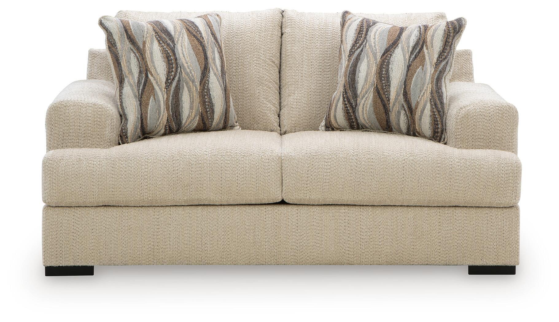 Beige loveseat with tufted back cushions and two striped throw pillows