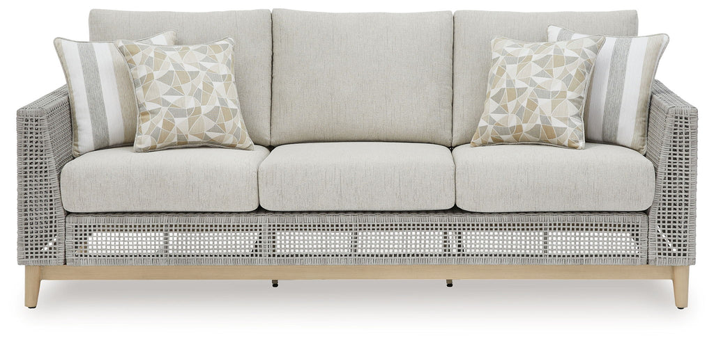Gray woven outdoor sofa with three-seat bench and two patterned pillows
