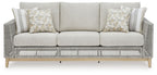 Gray woven outdoor sofa with three-seat bench and two patterned pillows