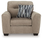 Light brown accent chair with a striped throw pillow centered on the seat