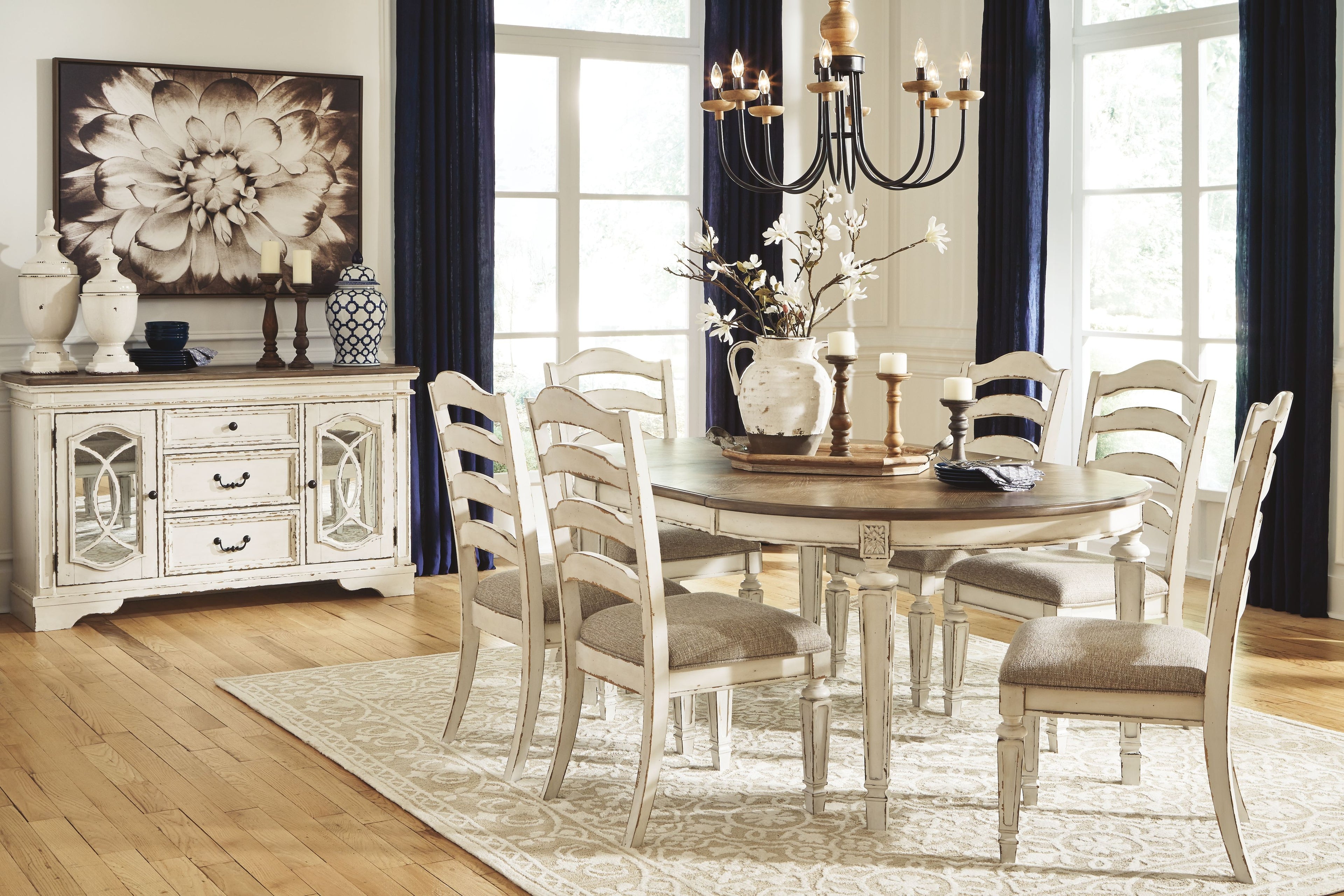 Oval dining table set with white ladderback chairs and gray-brown tabletop