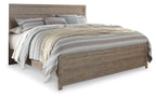 Gray wood panel bed with slatted headboard and footboard, shown with patterned bedding
