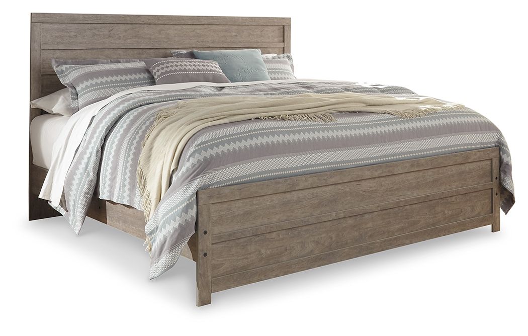 Gray wood panel bed with slatted headboard and footboard, shown with patterned bedding