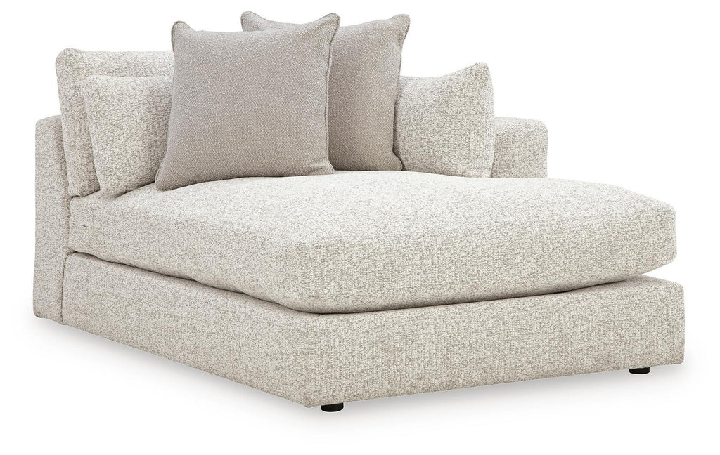Corner chaise with light beige upholstered seat and back cushions, rounded armrest