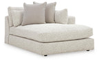 Corner chaise with light beige upholstered seat and back cushions, rounded armrest