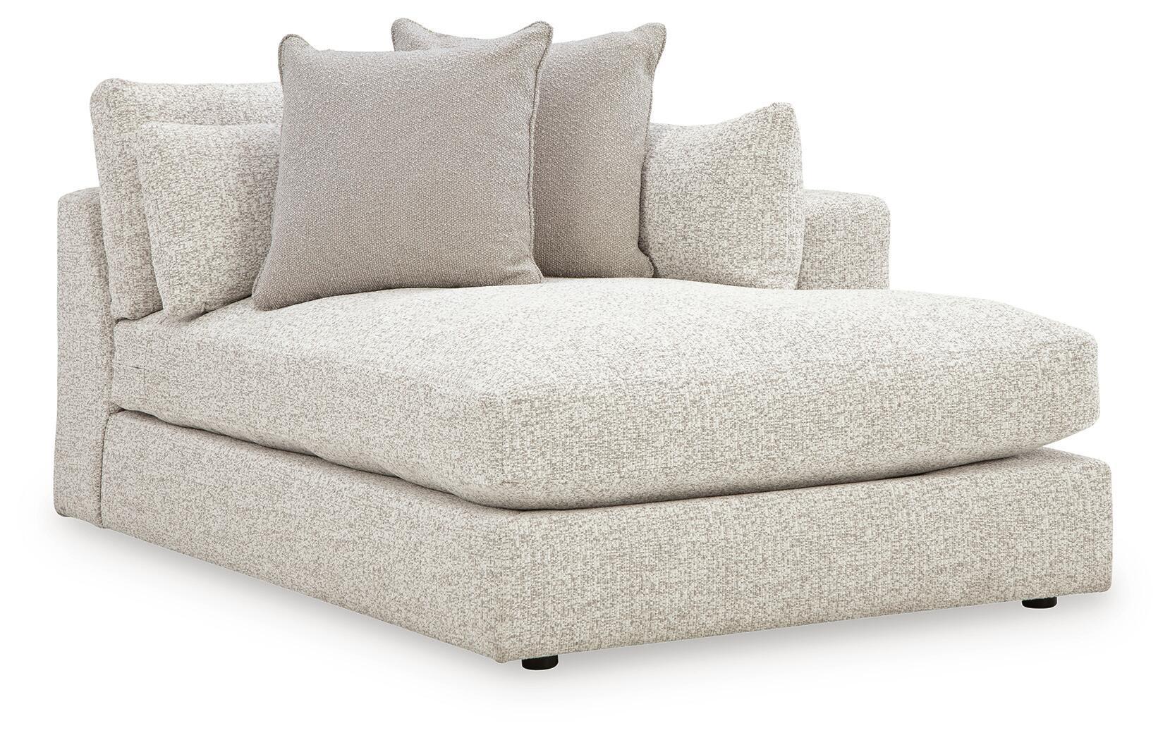 Corner chaise with light beige upholstered seat and back cushions, rounded armrest
