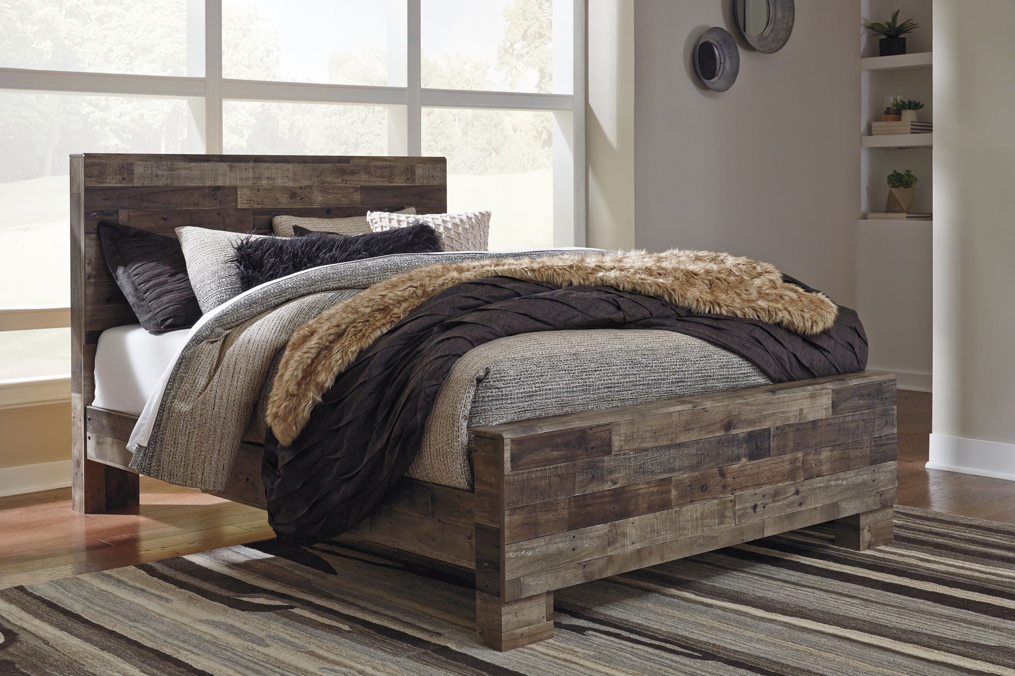 Rustic panel bed with dark wood frame, gray bedding and black blanket with tan fur throw