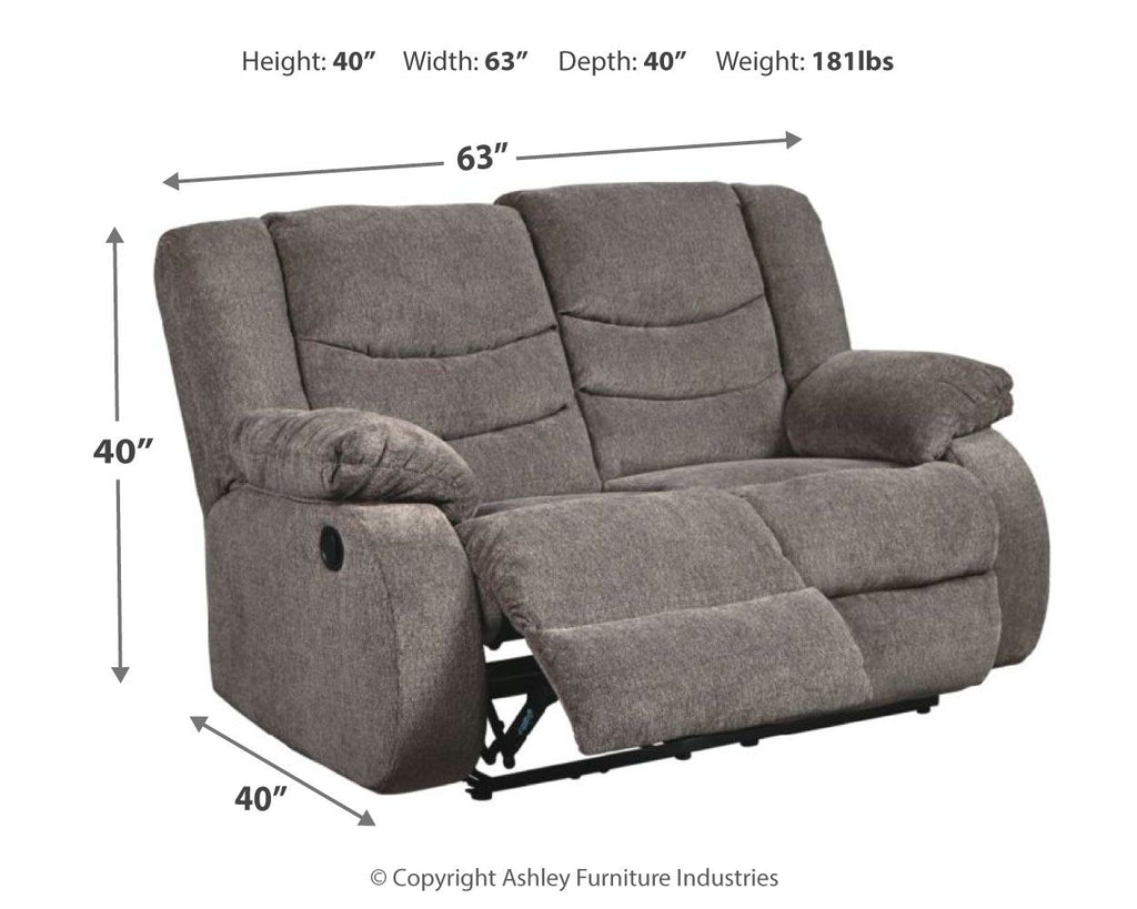 Gray reclining loveseat shown at an angle with pull-out leg support and side lever