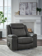 Dark gray rocker recliner chair with tall backrest, stitched seat, and padded armrests.