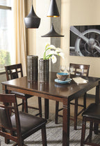 Brown counter-height table with four matching chairs, set of five