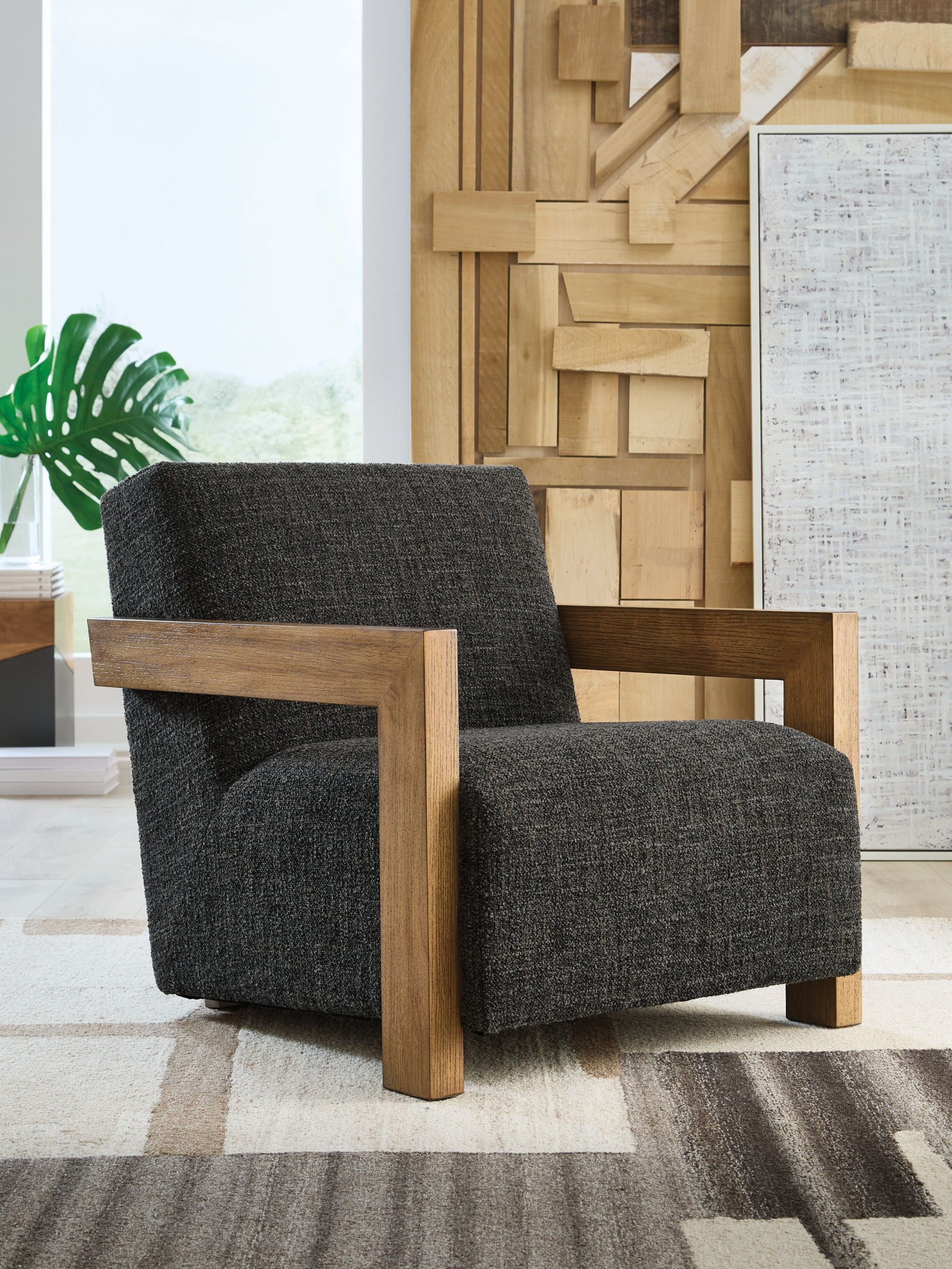 Charcoal fabric accent chair with broad back, wooden arms, and sturdy square base