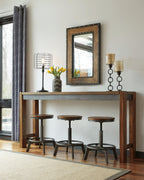 Dark brown long counter table with five matching bar stools and wall mirror