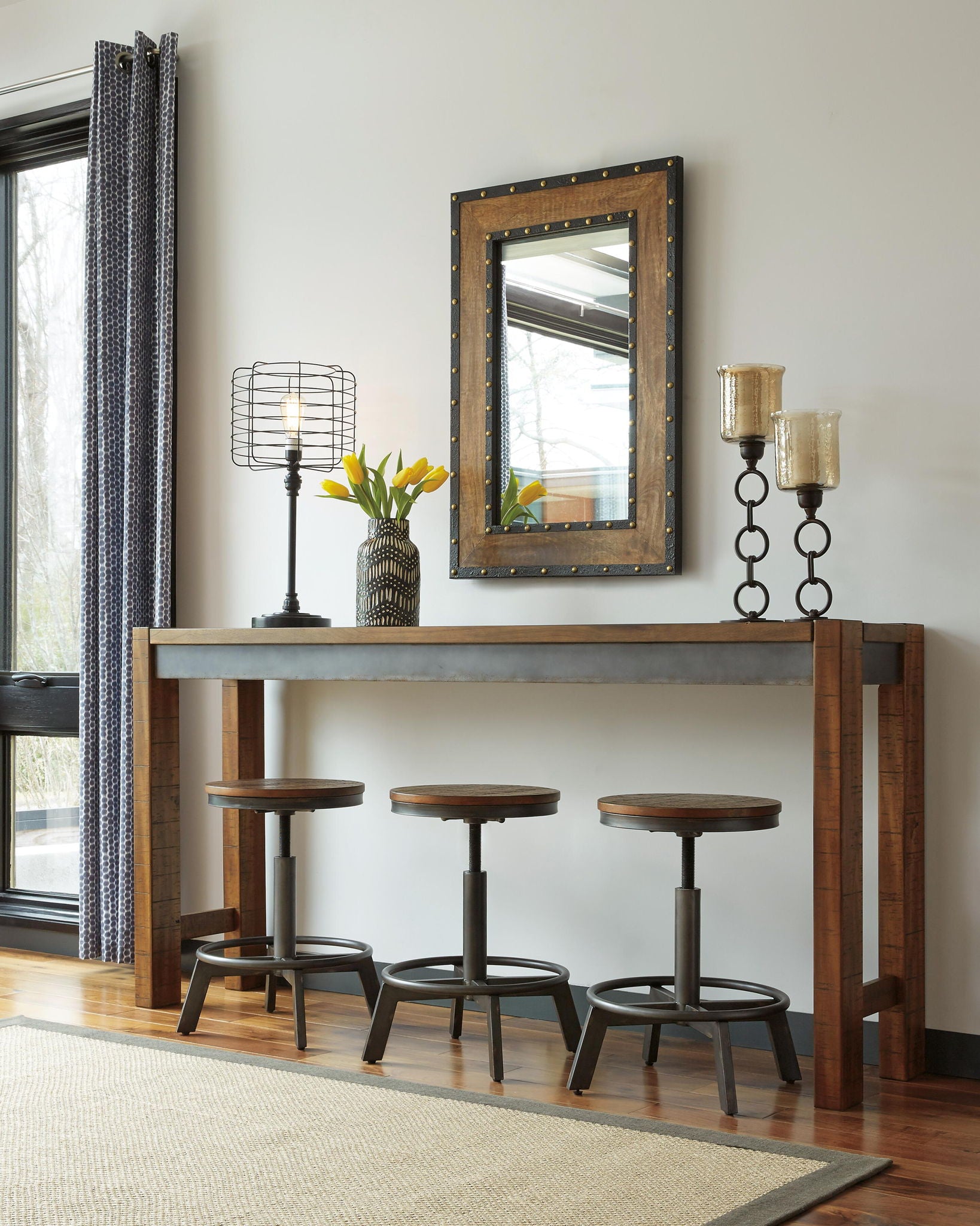 Dark brown long counter table with five matching bar stools and wall mirror