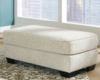 Rectangular ottoman with light beige upholstery and black legs