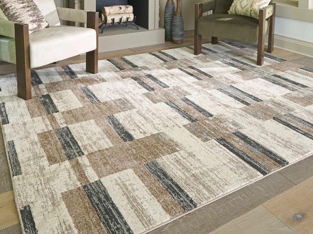 Beige abstract block-pattern area rug with dark gray bands and tan highlights