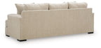 Beige upholstered sofa with three back cushions and black feet