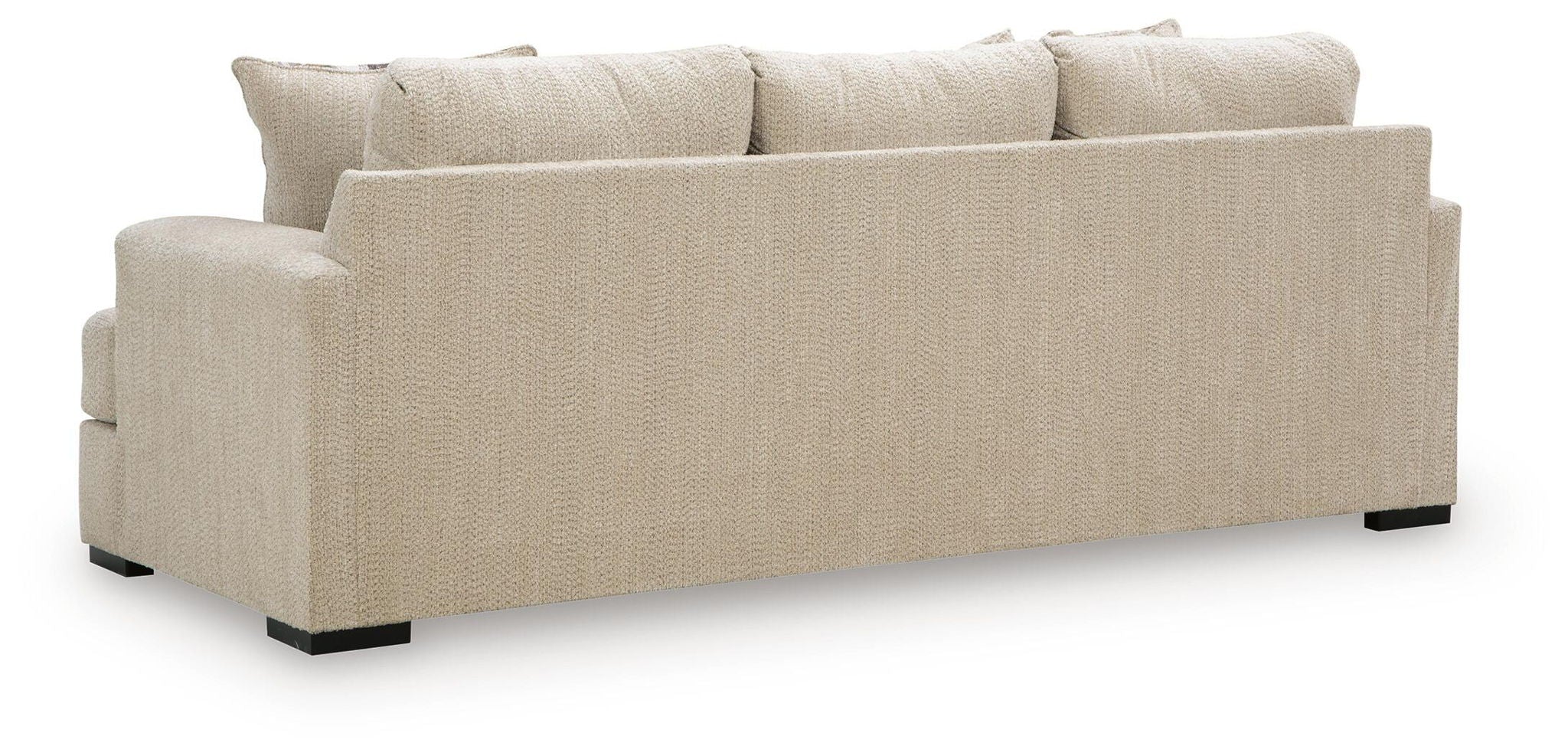 Beige upholstered sofa with three back cushions and black feet