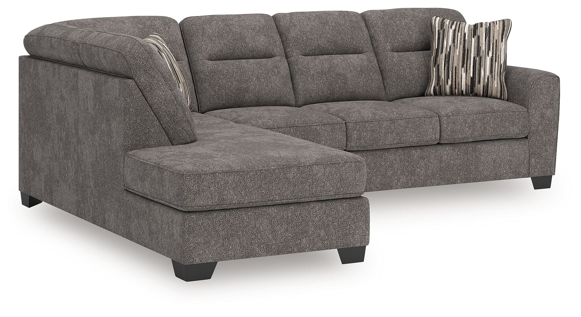 Dark gray sectional sofa with chaise, tufted back cushions, and two accent pillows on arms