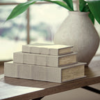 Light beige fabric keepsake box set with stacked boxes on tabletop