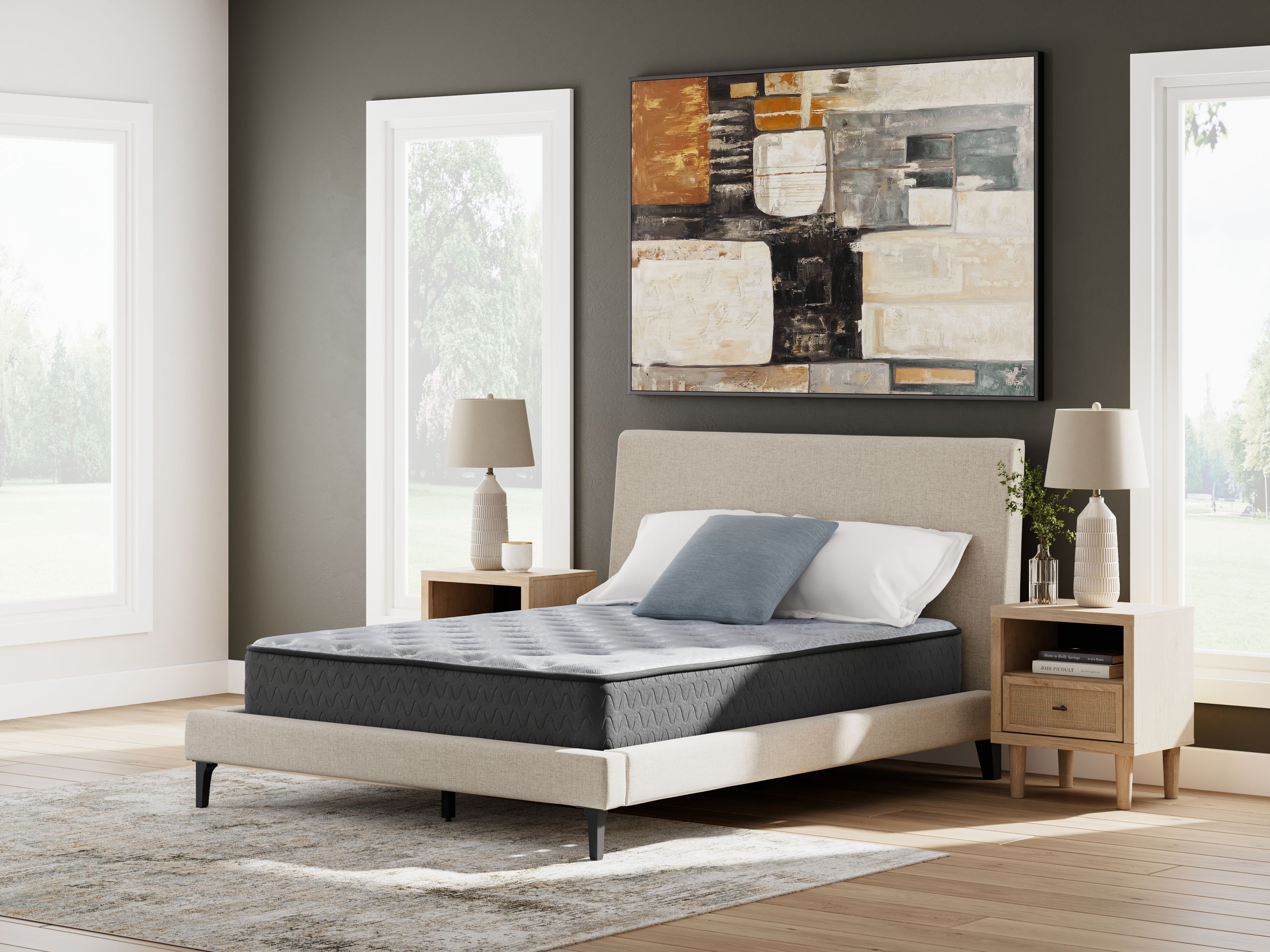 Gray mattress on bed with pillows and headboard