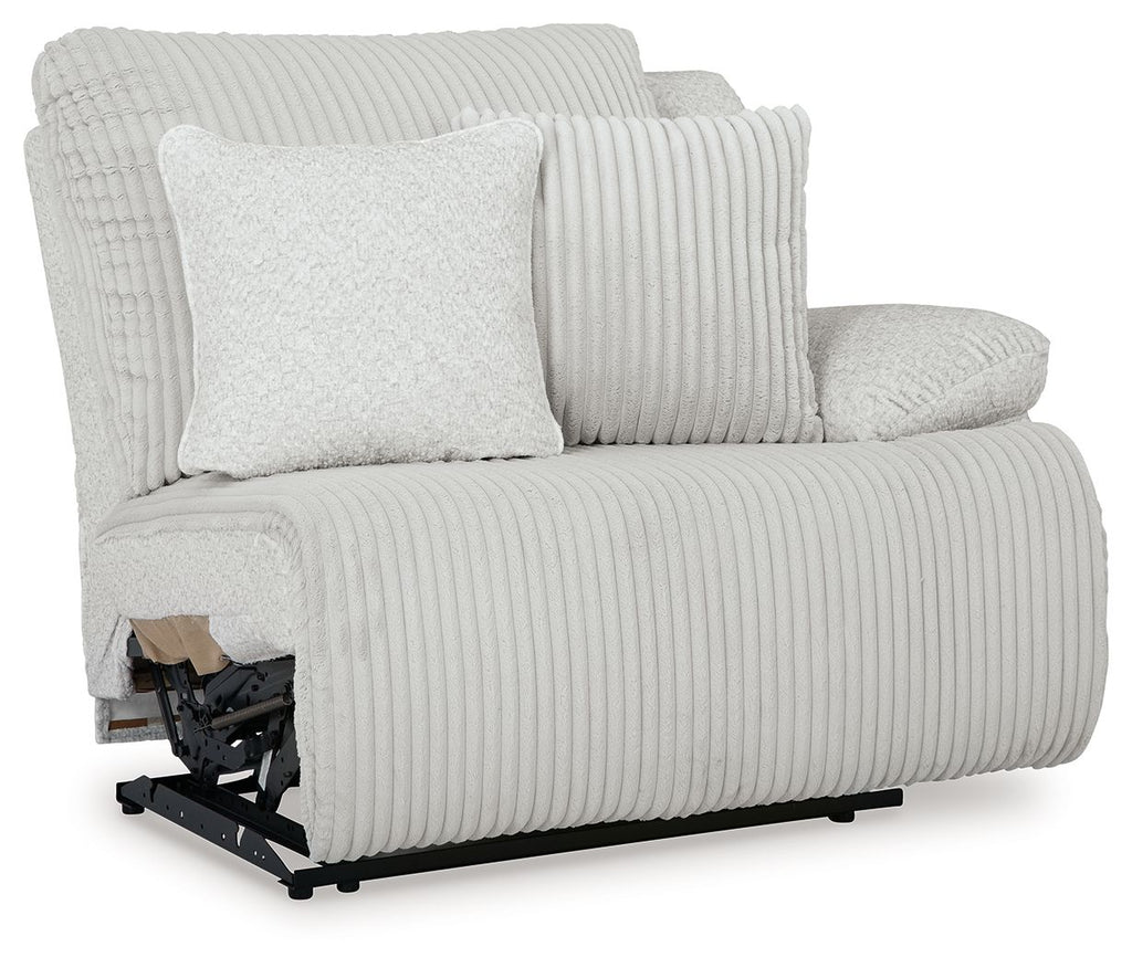 Light gray wall recliner with ribbed fabric, two cushions, and fold-out footrest