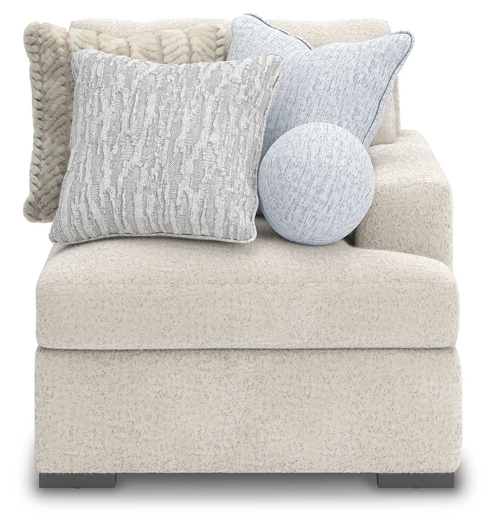 Fabric corner chair with textured light gray upholstery, block feet, and plush lumbar pillows