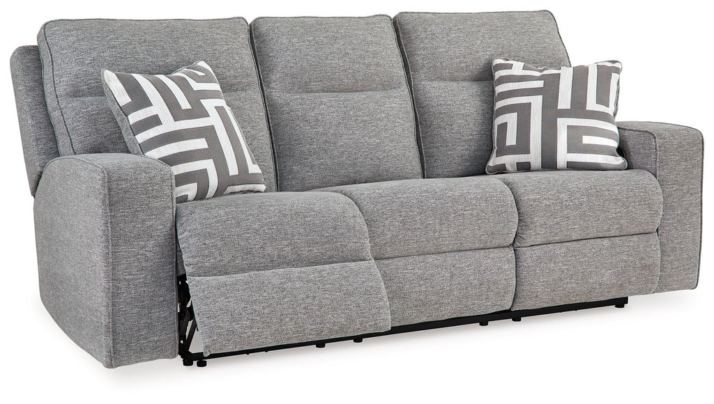 Pewter power reclining sofa in gray fabric with patterned pillows and visible extended footrests