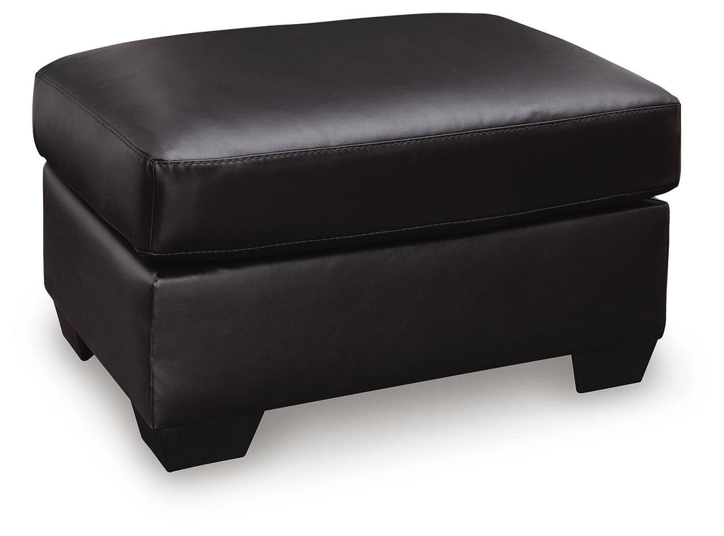 Glennbre ottoman in dark upholstery, padded square top, stitched seams, short legs