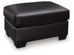 Glennbre ottoman in dark upholstery, padded square top, stitched seams, short legs