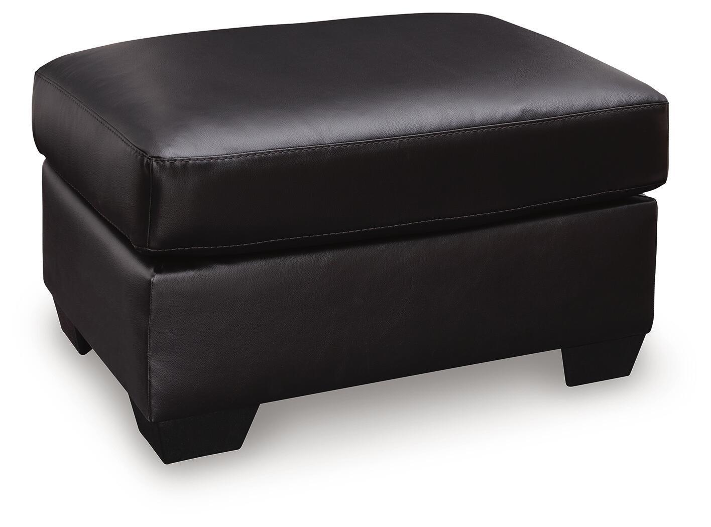 Glennbre ottoman in dark upholstery, padded square top, stitched seams, short legs