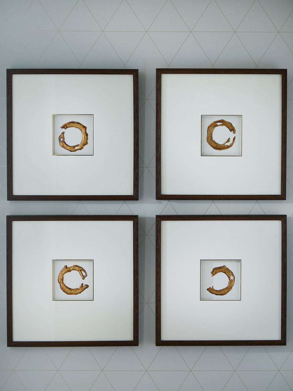 Set of 4 framed wall art prints with white backgrounds and gold abstract circular shapes