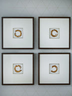 Set of 4 framed wall art prints with white backgrounds and gold abstract circular shapes