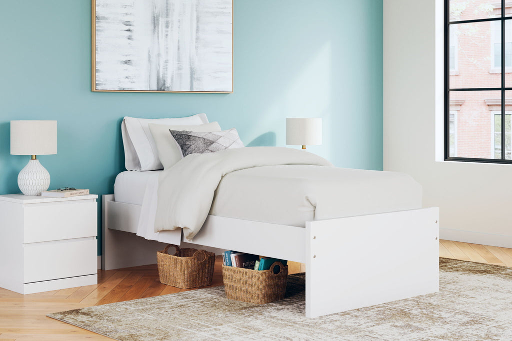 White platform bed with open side storage showing beneath-bed space