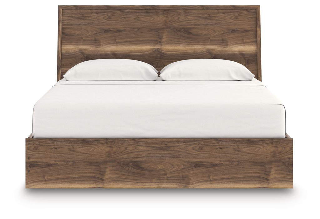 Dark brown panel bed with slatted headboard and white pillows on mattress