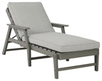 Gray chaise lounge chair with attached cushion, reclined back and side arms
