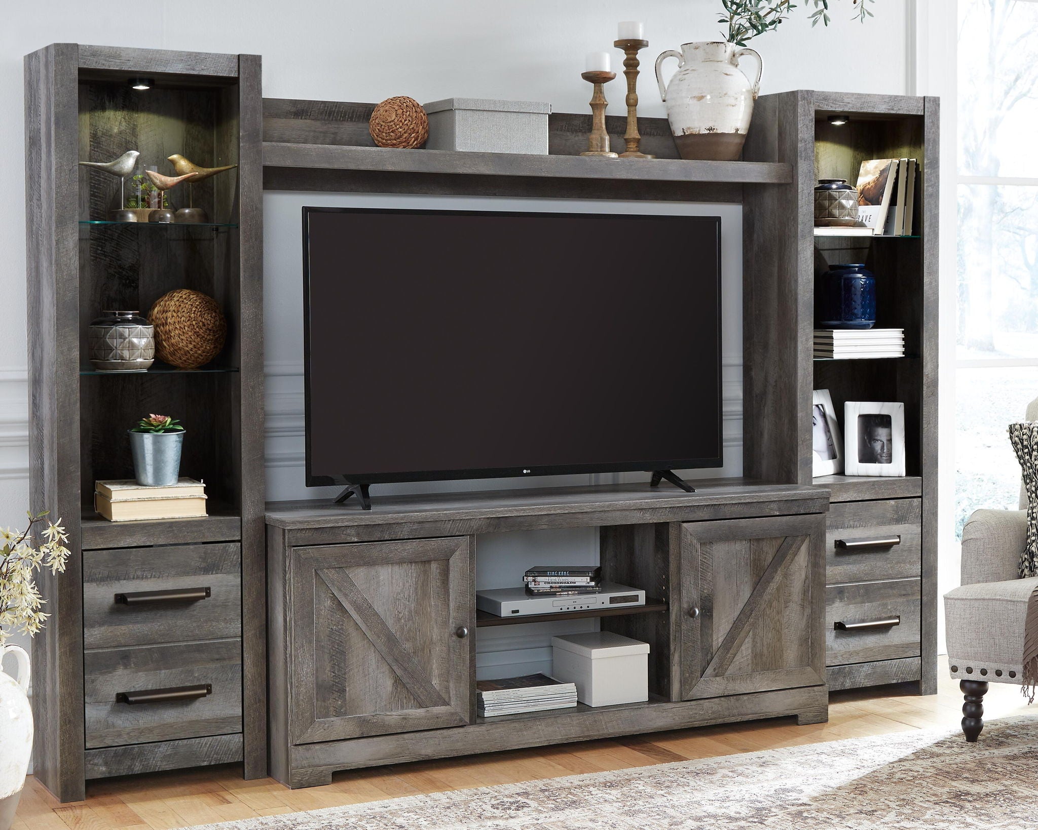 Gray entertainment center with TV opening, open shelves, and storage drawers