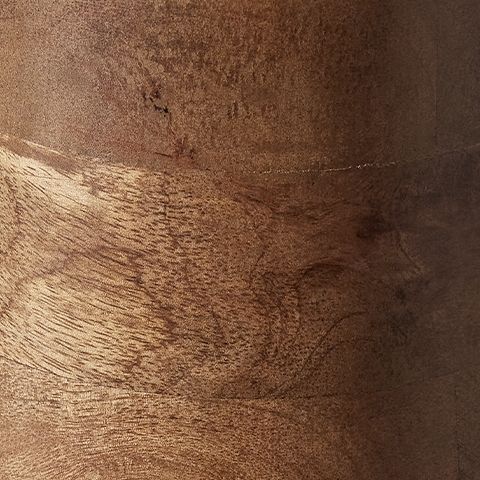 Wood lamp base close-up showing layered grain rings and dark brown finish