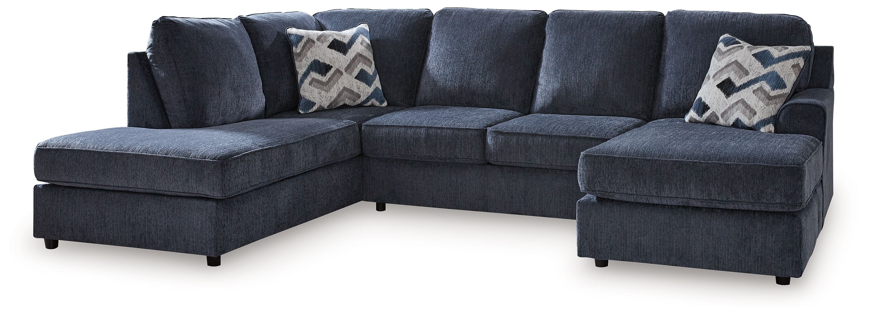Cobalt blue L-shape sectional sofa with chaise and two patterned accent pillows