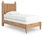 Light brown wooden panel bed with white mattress and pillow, side view