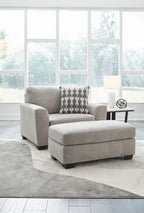Gray upholstered armchair with matching ottoman