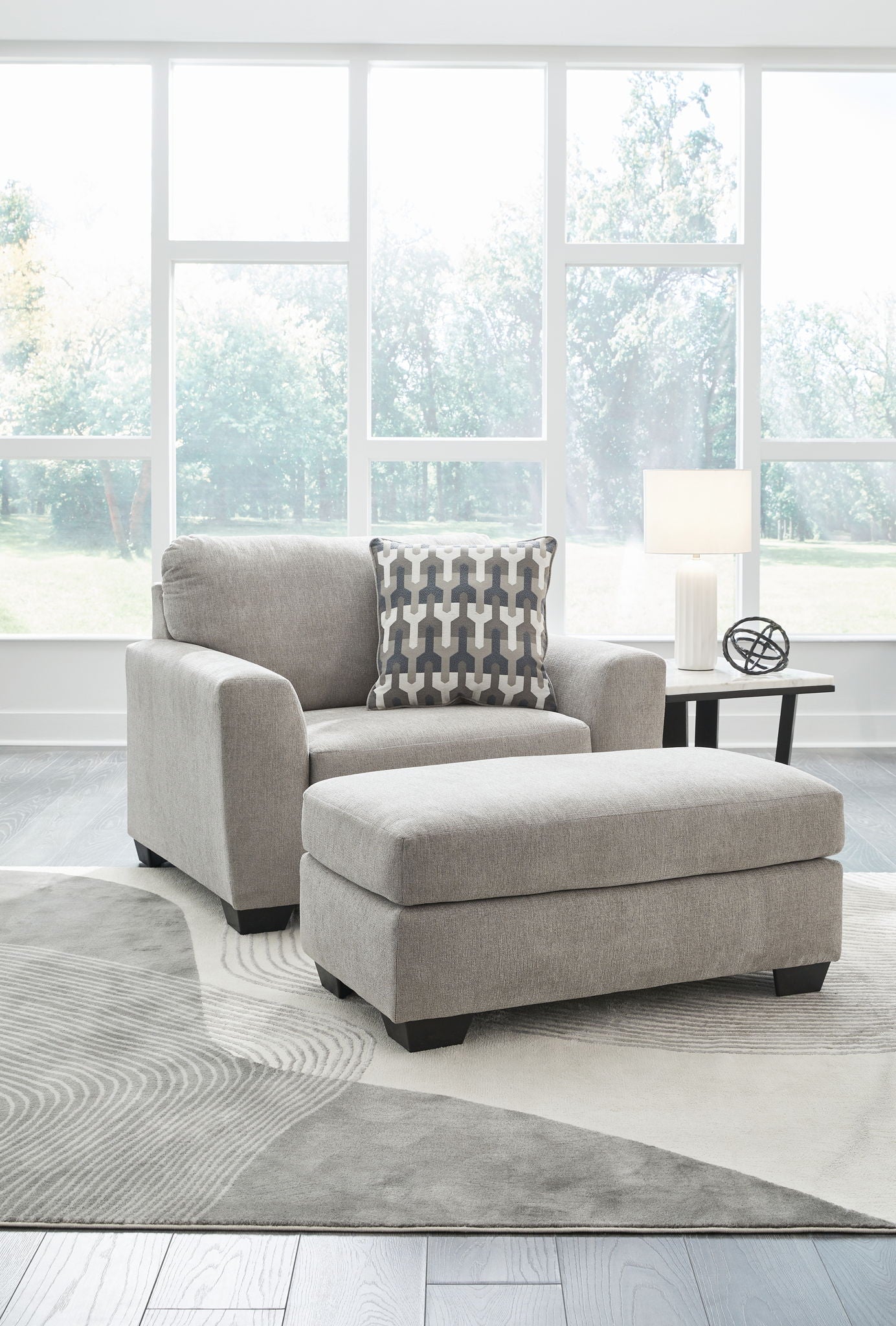 Gray upholstered armchair with matching ottoman