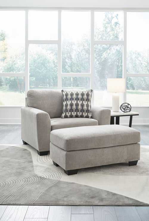 Gray upholstered armchair with matching ottoman