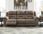 Power reclining sofa in dark brown plush fabric with padded arms