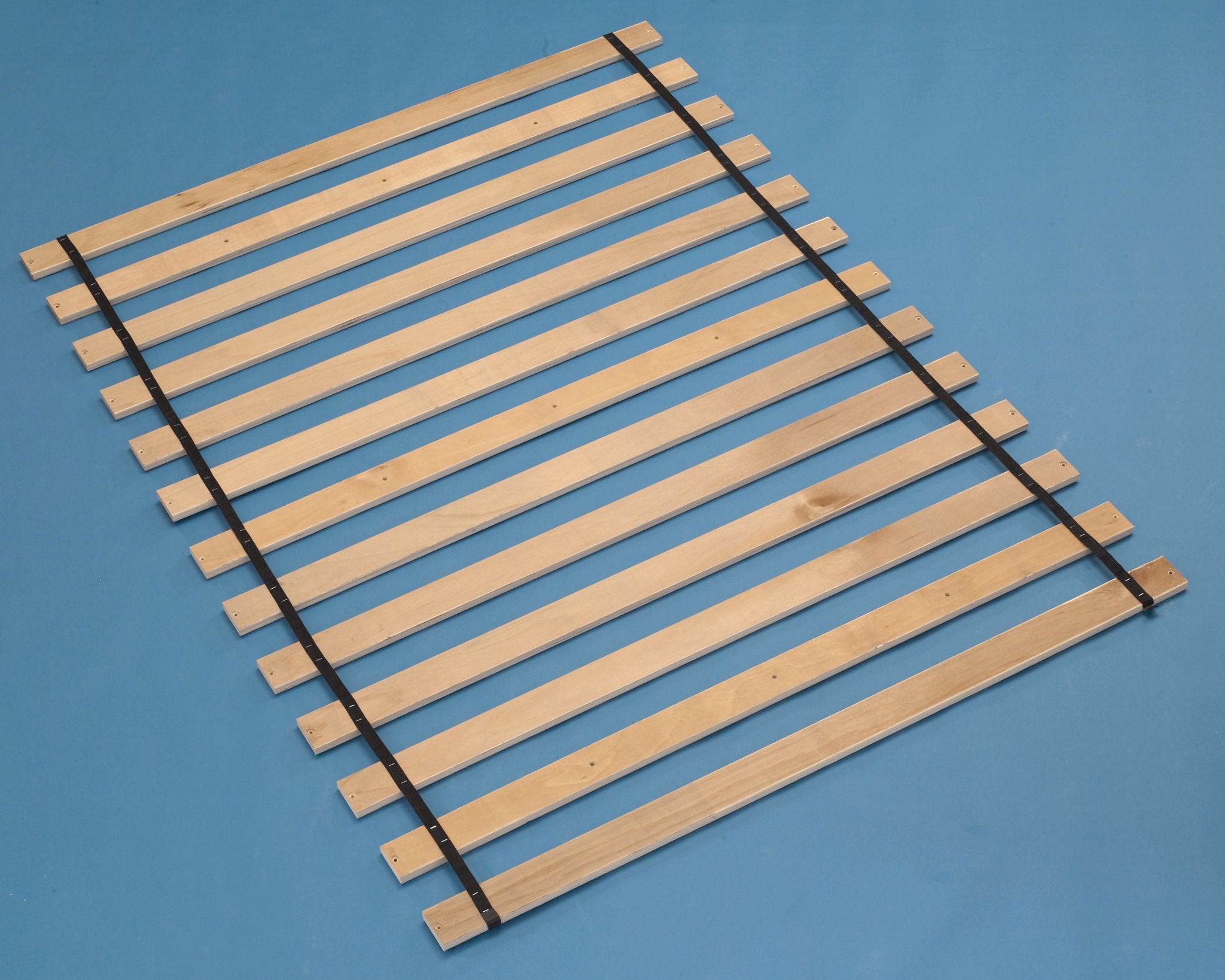 Brown wooden slat platform base with dark support straps