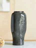 Dark speckled ceramic vase with glossy finish and flared open top