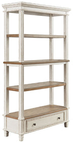 Brown and white wood bookcase with open shelves and a bottom drawer.
