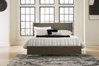 Grayish-brown panel bed with white-and-gray striped bedding and pillows