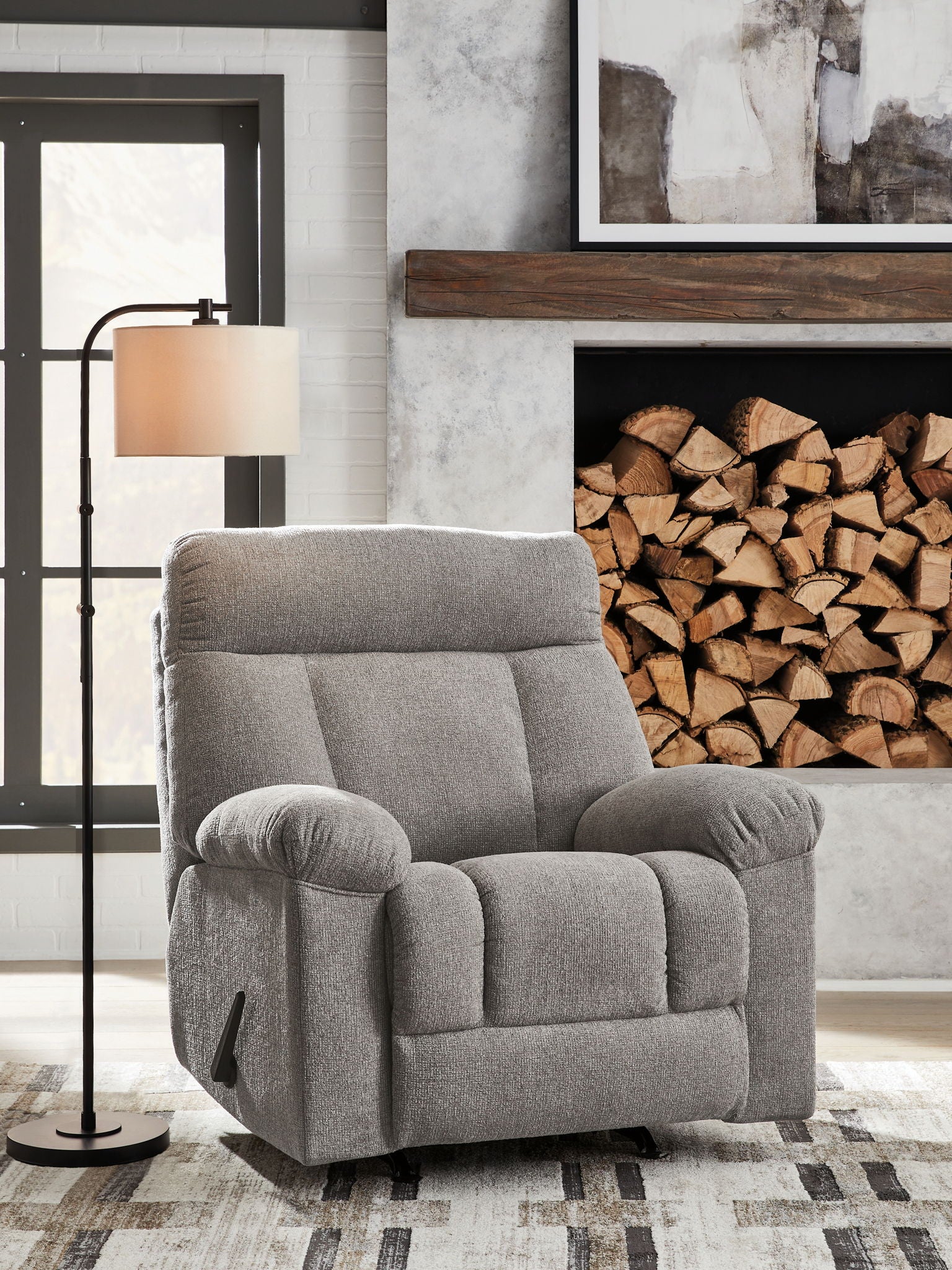 Rocking recliner chair in medium gray fabric, padded arms and recline seats