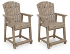 Two Seacliff Beach barstools, medium-brown wood with slatted backs and armrests